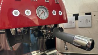 The Smeg Espresso Coffee Machine EGF03 with the portafilter in-situ