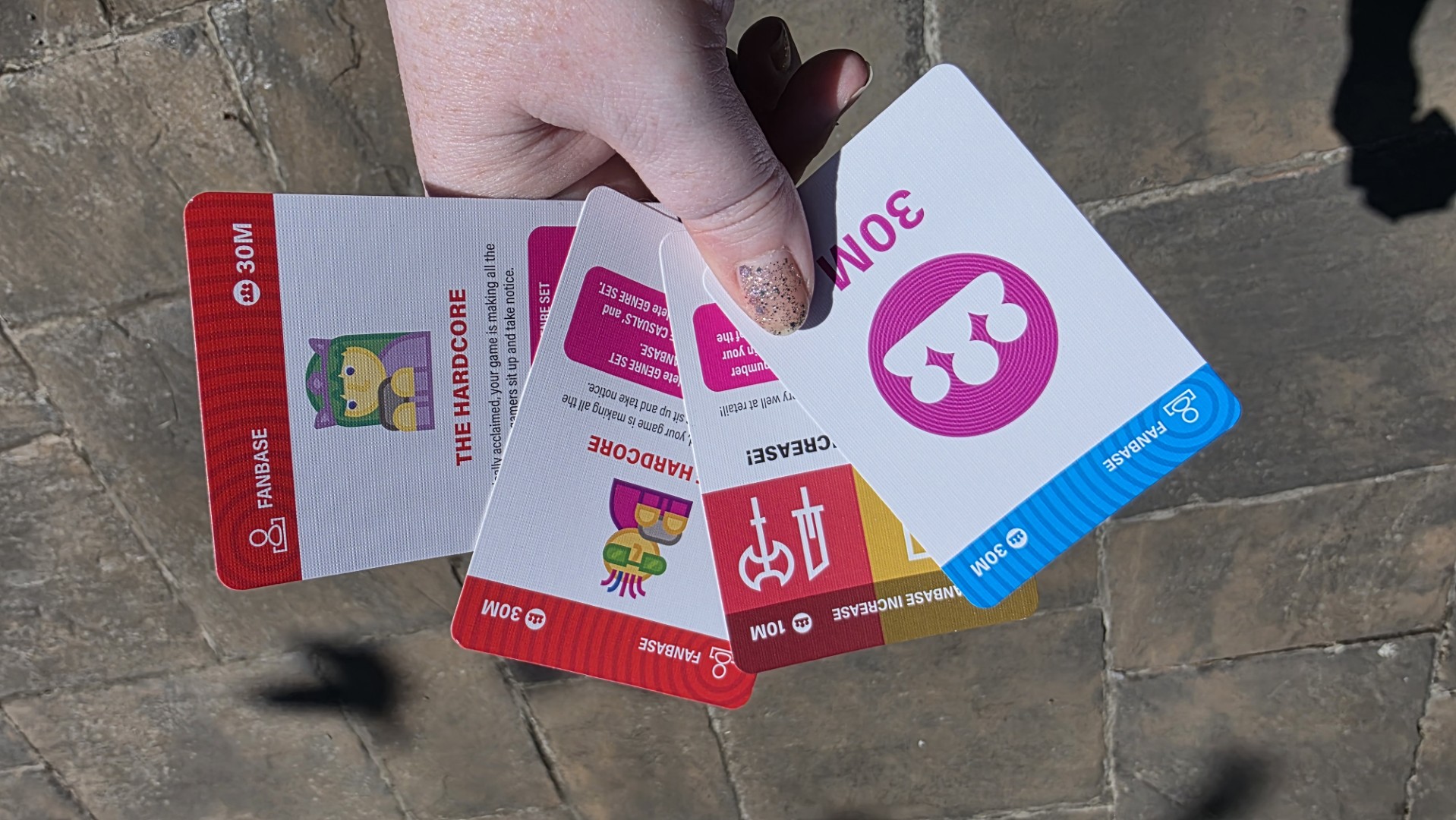 Cards from Console Wars held in hand