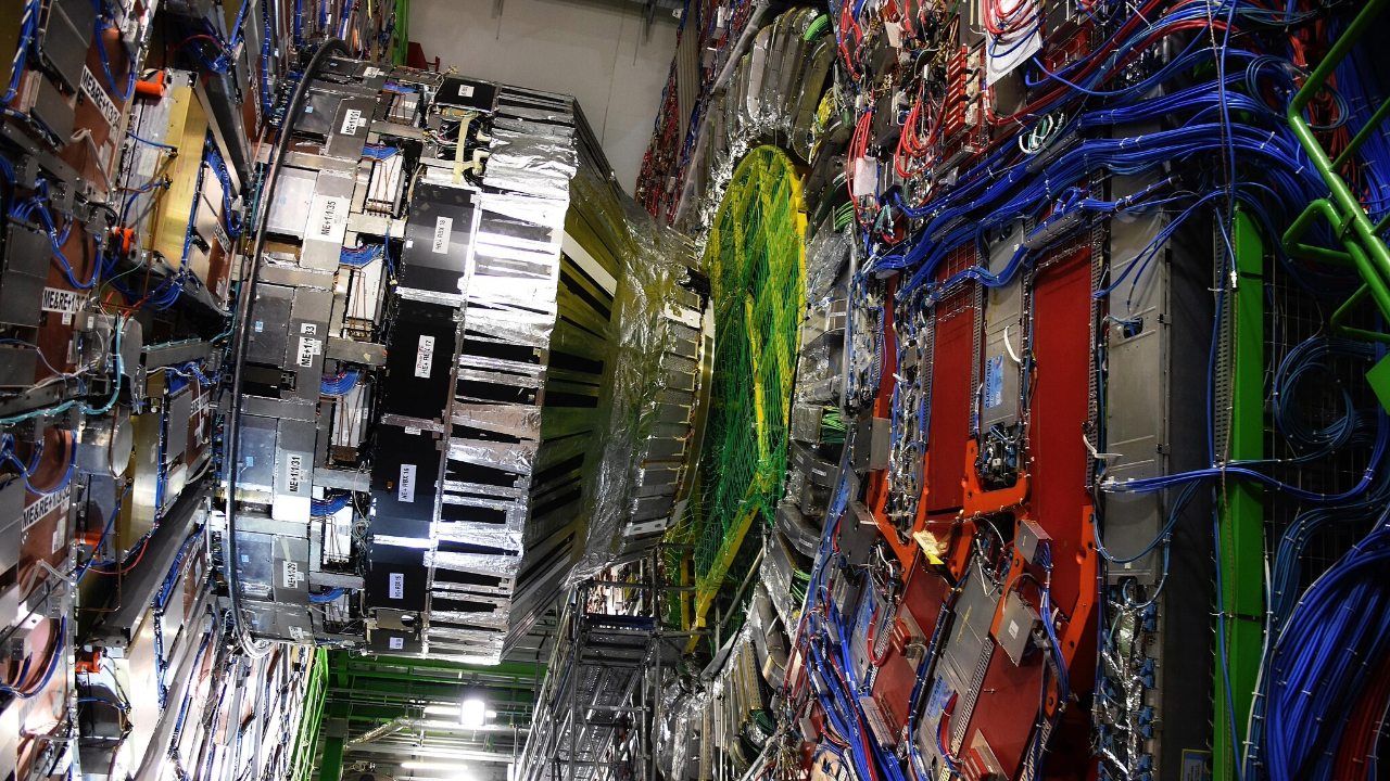 A view of the Large Hadron Collider, a metal interface with lots of wires and pipes.
