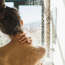 back view of woman taking shower