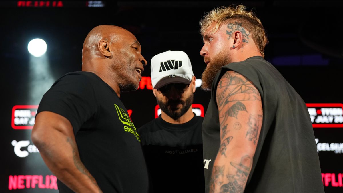 Jake Paul and Mike Tyson facing off at a press conference in advance of their boxing match on Netflix.