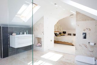 open plan bathroom with travetine flooring