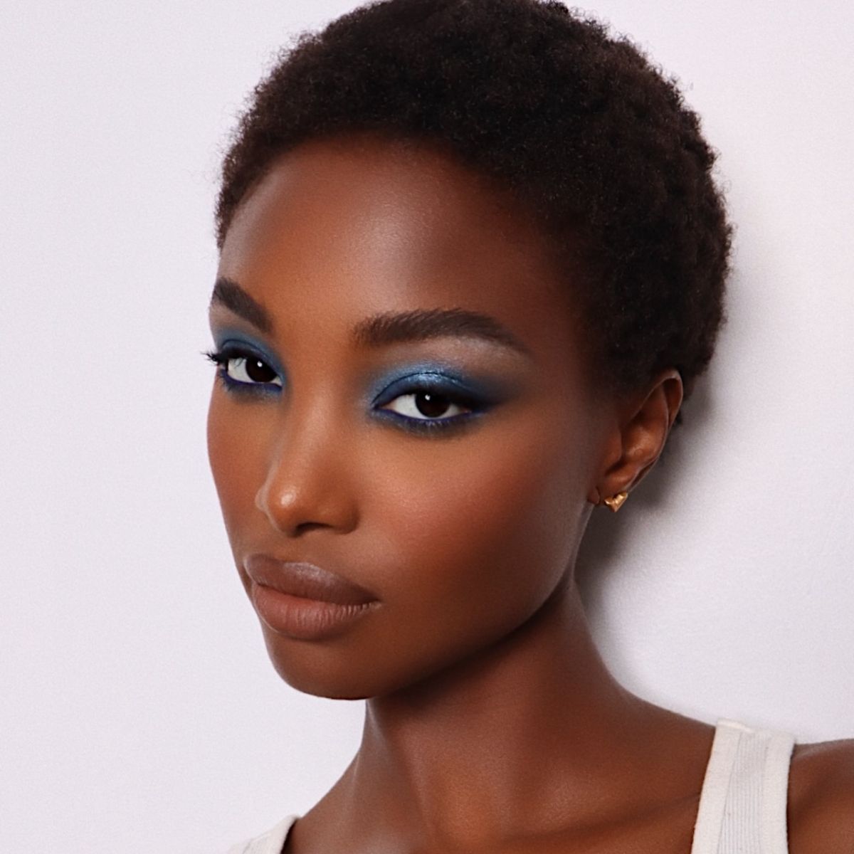A woman wearing blue eye shadow