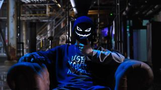 The Devil's Plan host sitting in a chair.