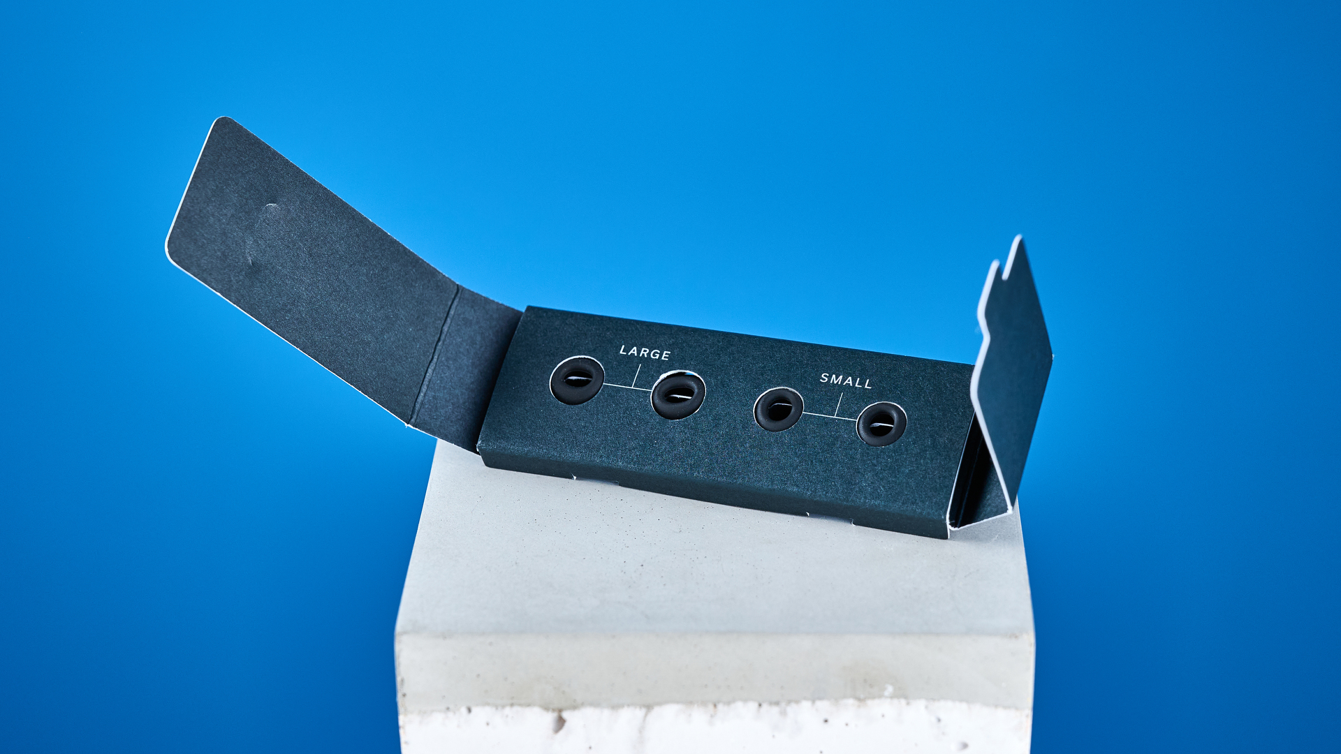 A pair of black Status Pro X wireless earbuds