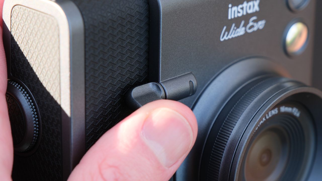 Close up of the shutter button on a Fujifilm Instax Wide Evo