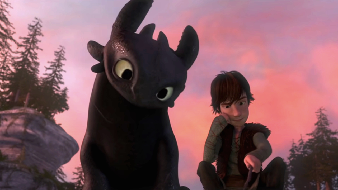 Toothless looks over Hiccup's shoulder as he draws in How to Train Your Dragon.