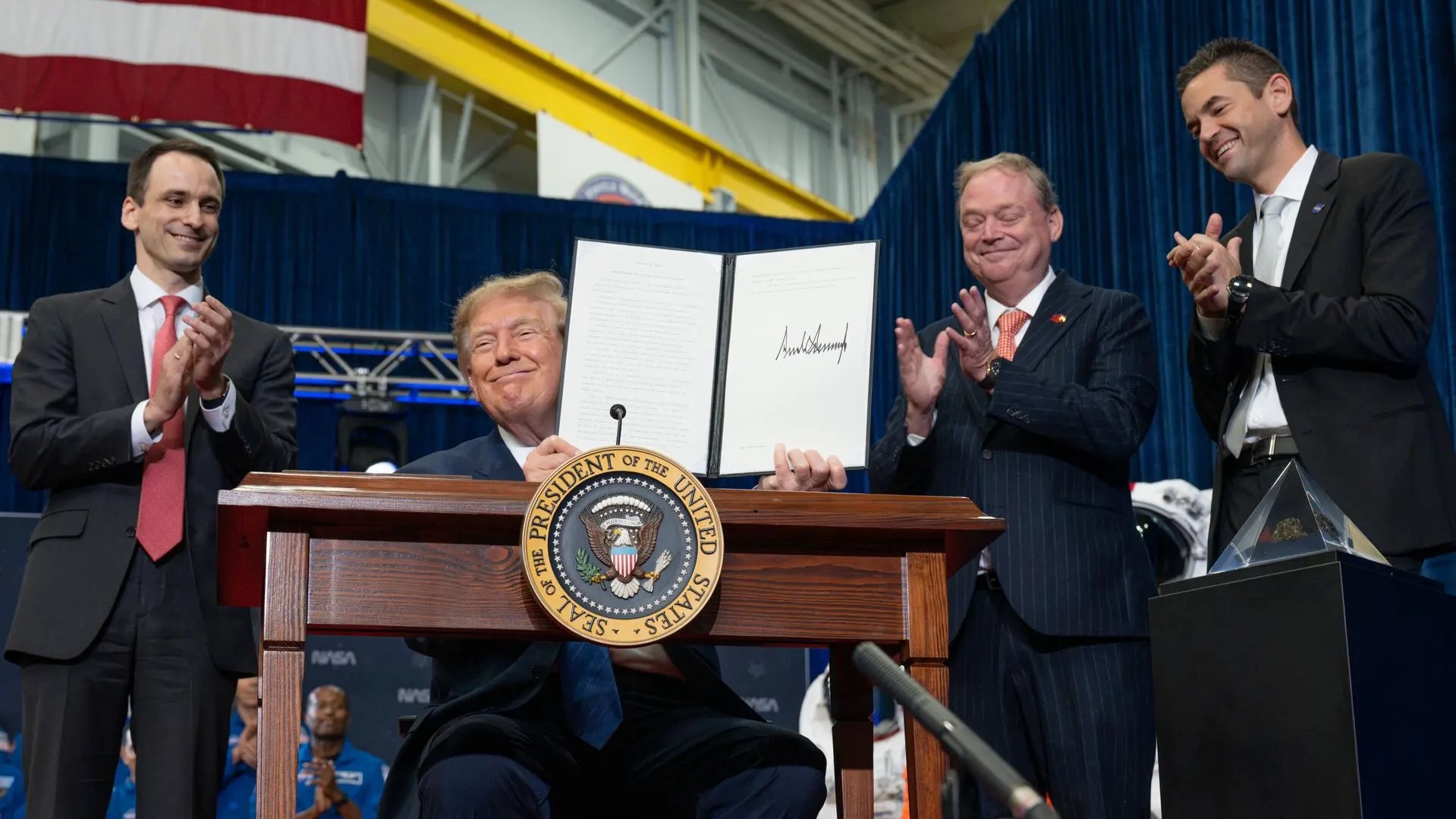 President Donald Trump presents an executive order establishing the United States Space Academy during an event to award the Congressional Space Medal of Honor to the Artemis II crew on Aug. 28, 2026, at NASA&rsquo;s Johnson Space Center in Houston.