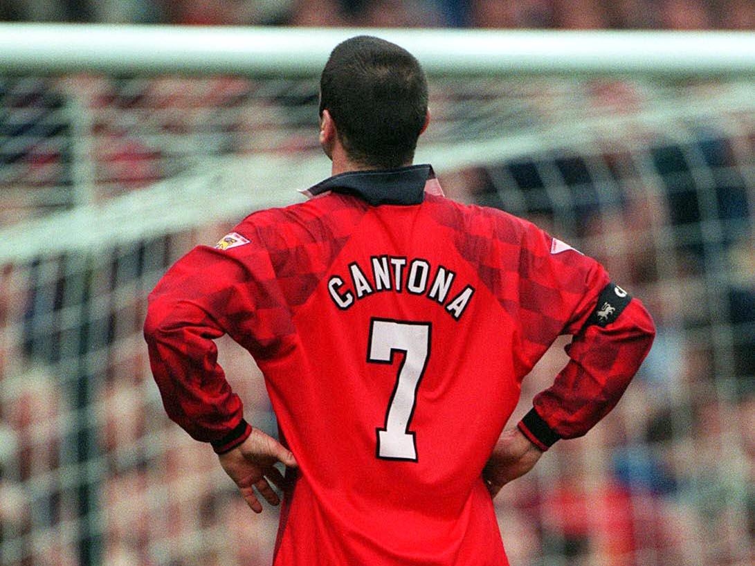 A photo taken from behind of Manchester United's Eric Cantona standing with his hands on his hips, 1997