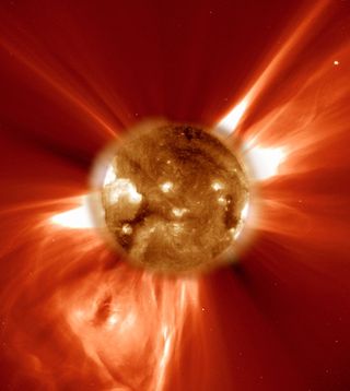 A snapshot of a coronal mass ejection firing off the surface of the sun, captured by NASA's SOHO spacecraft. This image shows the sun in ultraviolet light, while the field of view extends over 2 million kilometers, or 1.243 million miles, from the solar surface.