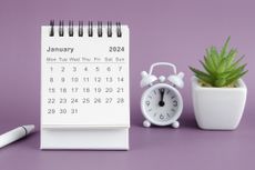 A calendar displaying the month of January in 2024. With a white alarm clock and a small plant on a purple background.