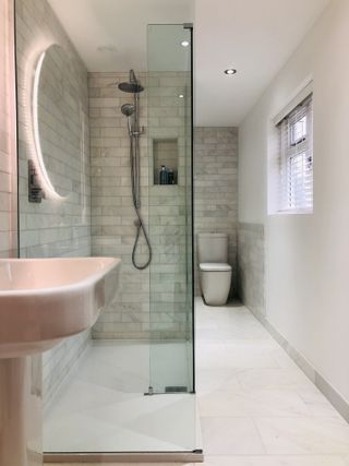 White wet room with panel return and pink colored units