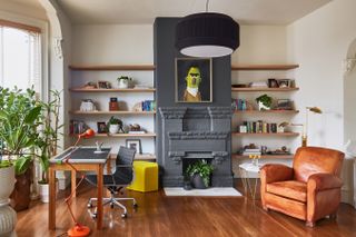 A home office with the fireplace painted in grey