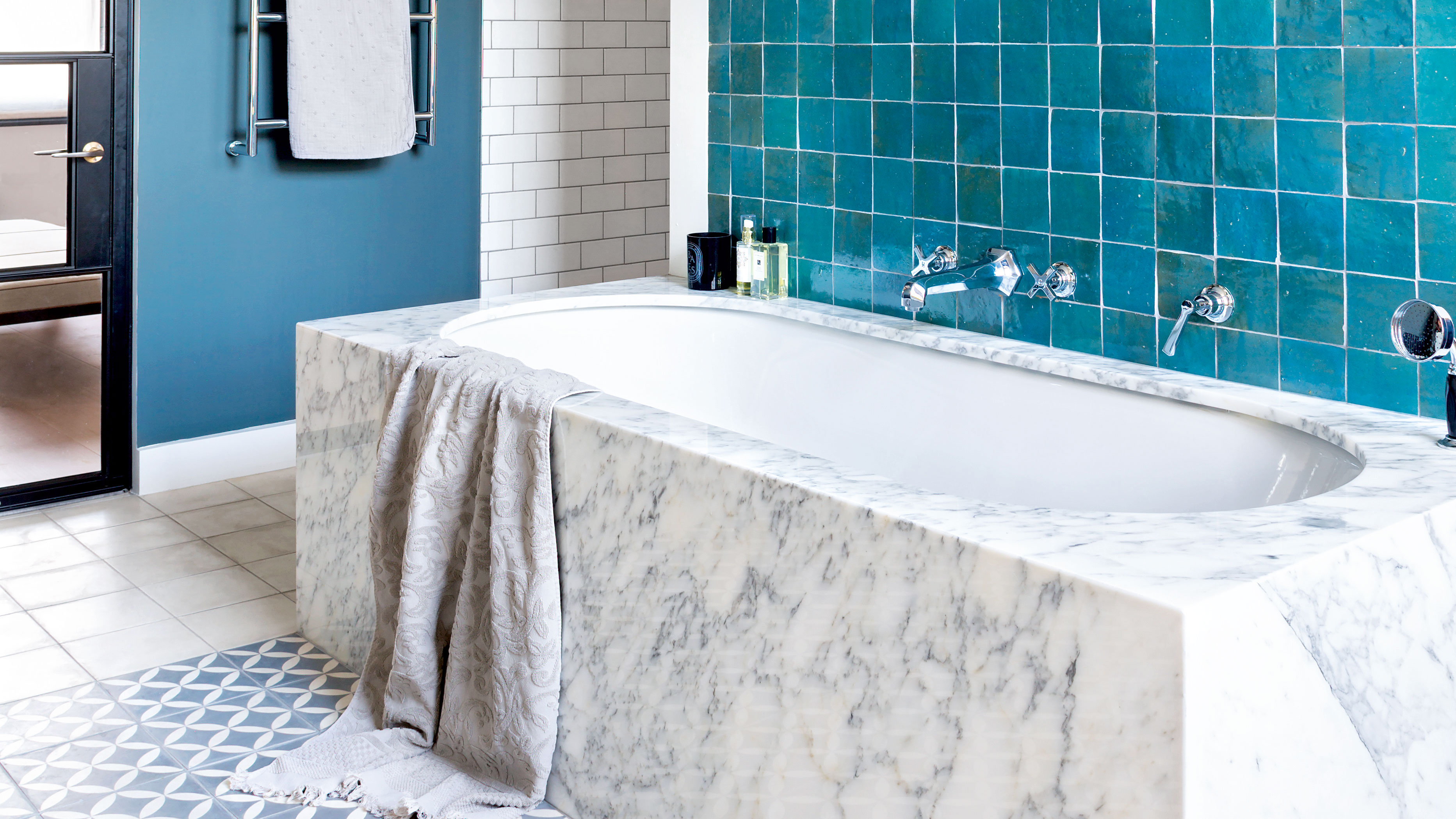 Modern bathroom with freestanding bathtub, modern taps and blue