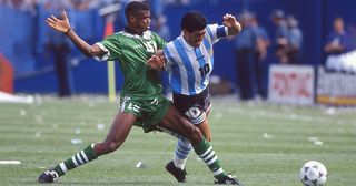Oliseh Sunday of Nigeria competes for the ball with Diego Maradona of Argentina FIFA World Cup 1994 match between Argentina and Niger at Foxboro Stadium on June 25, 1994 in Foxborough, Massachusetts, United States.