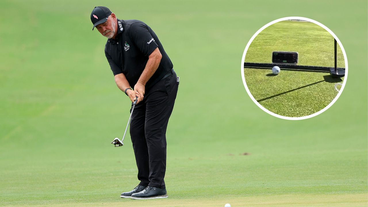 Darren Clarke hits a putt from the edge of the green