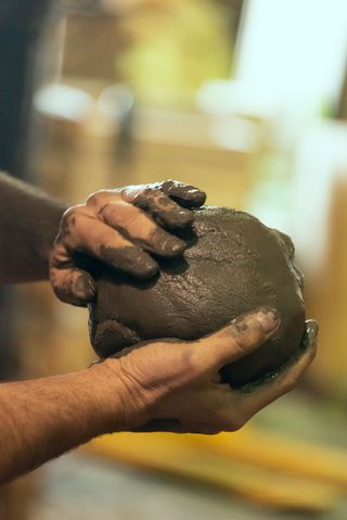 A clay sphere being moulded in Bosco Sodi's studio for his Tabula Rasa public art installation