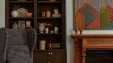 living room with comfortable armchair and bookcase