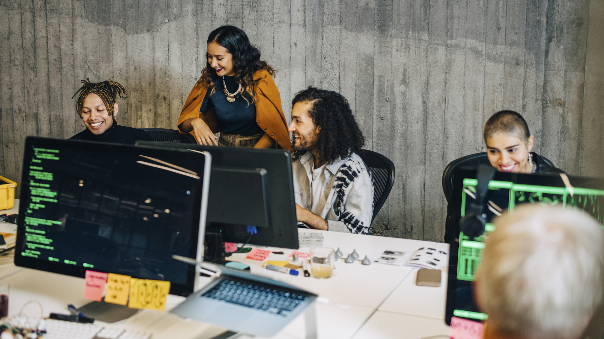 People in an office working on programming