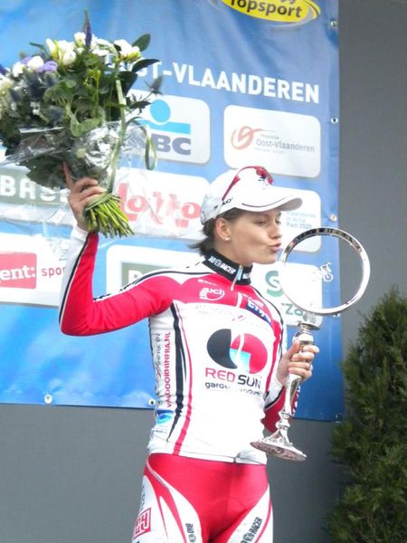 Emma Johansson (Red Sun Cycling Team) kisses her trophy after the Omloop Het Nieuwsblad