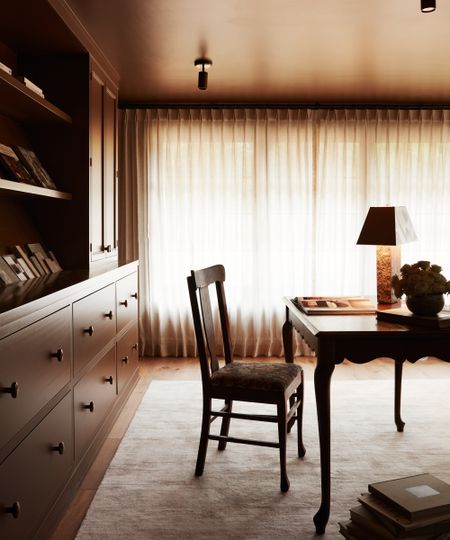 home office with brown walls and millwork