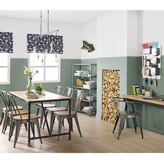 dining room with green and white wall and wooden flooring