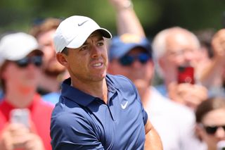 Rory McIlroy of Northern Ireland watches his shot from the first tee during the final round of the Travelers Championship at TPC River Highlands