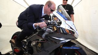 Prince William, Duke of Cambridge tries out a motorbike at the Isle of Man TT