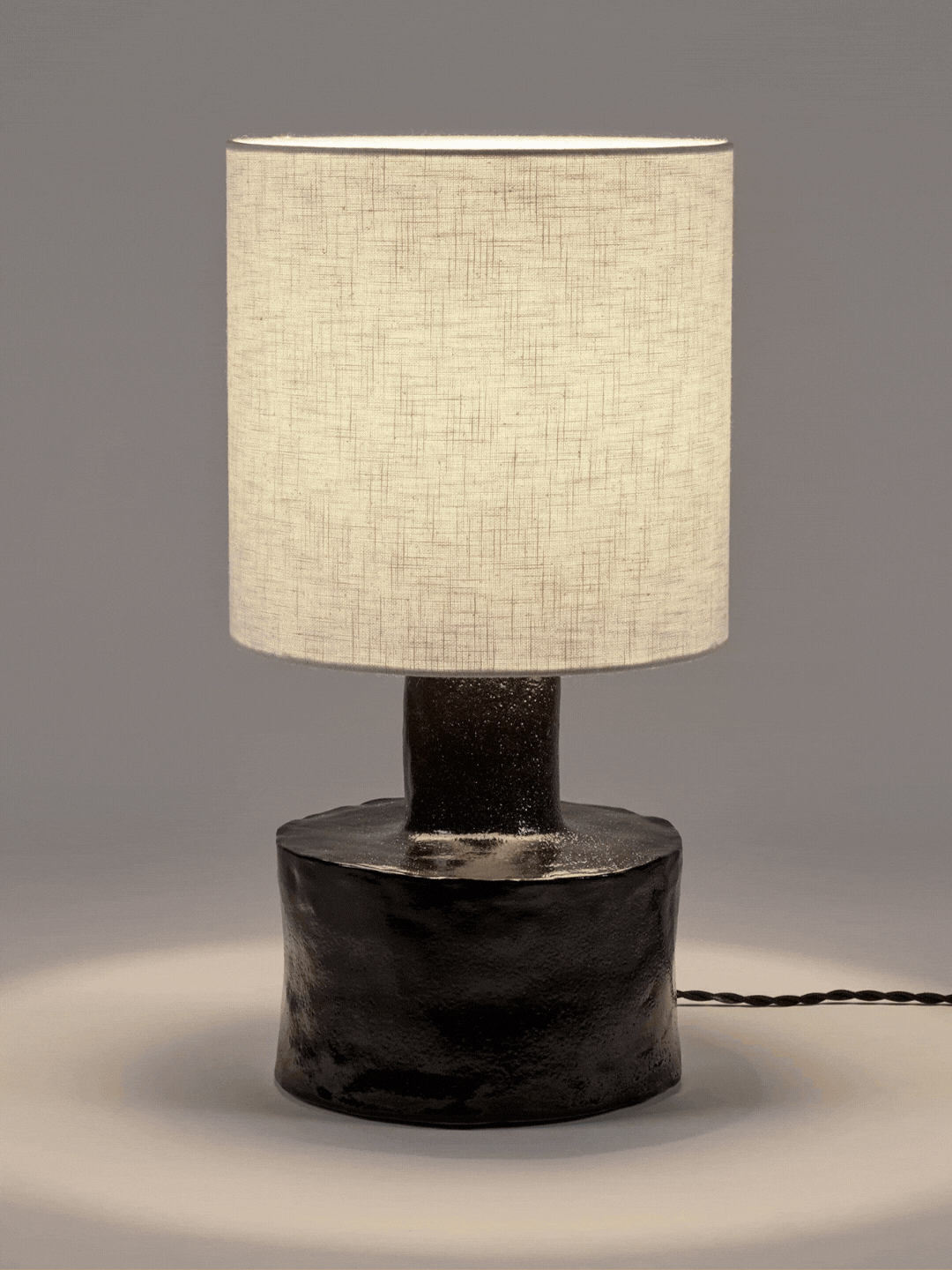 A stoneware lamp with a linen shade from SERAX by Marie Michielssen