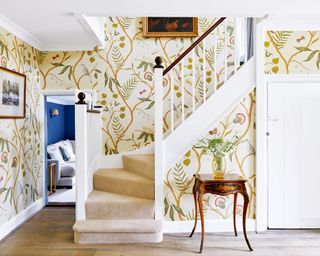 Entryway with floral wallpaper and classic furniture