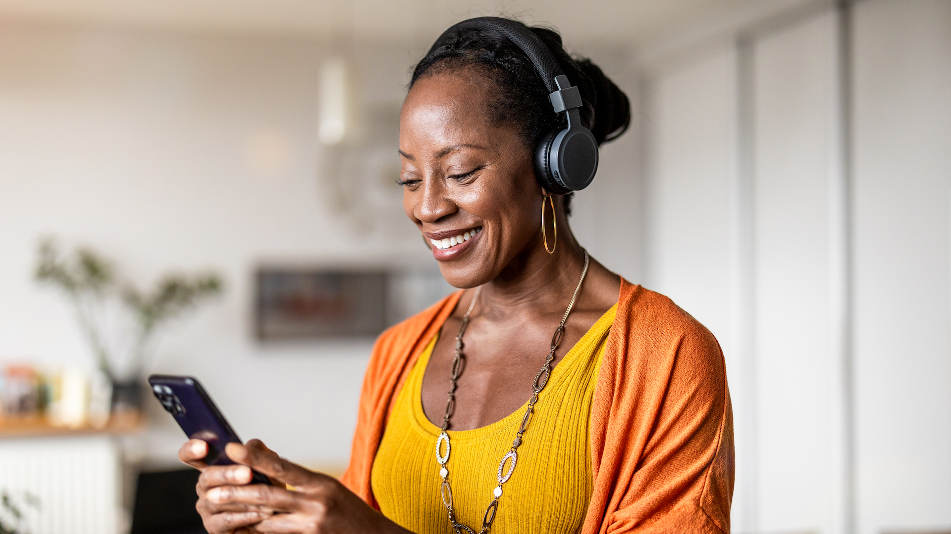 Woman smiling while looking at phone