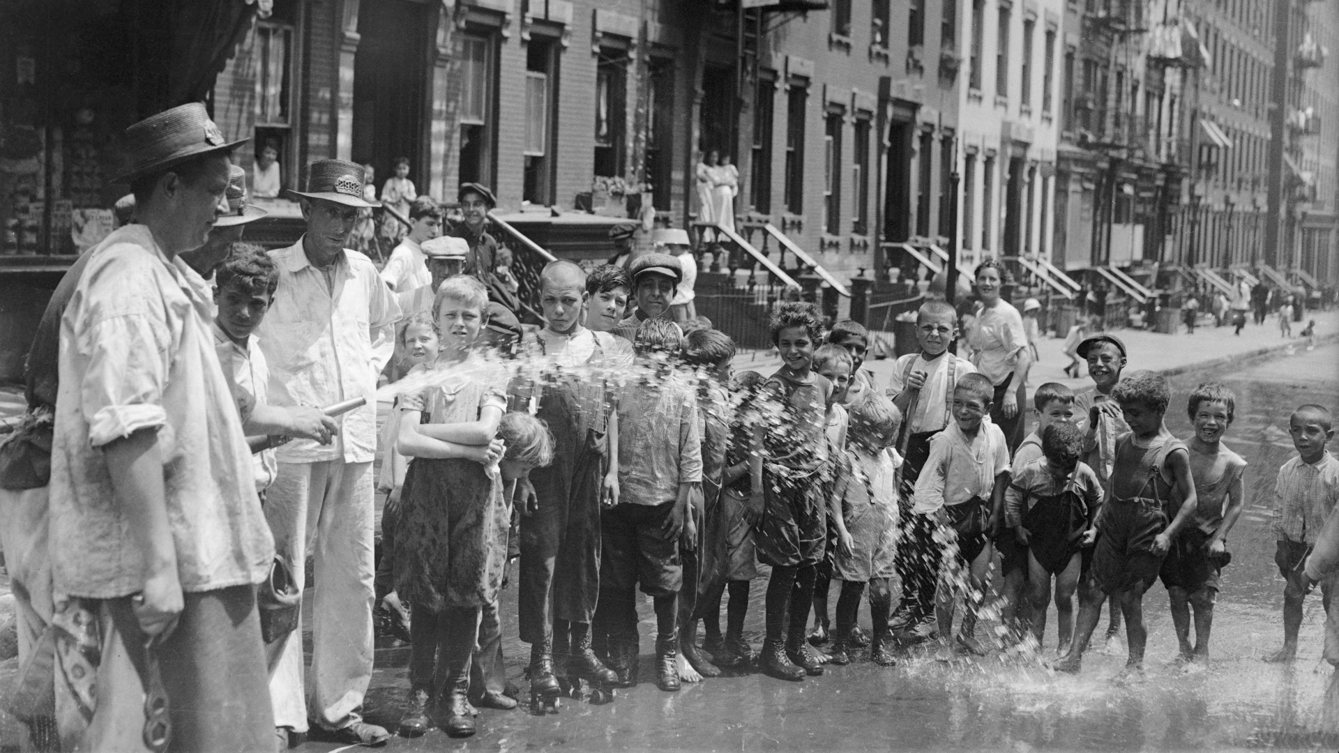 A street flusher tries to keep kids cool in New York on of the hottest days in 1915