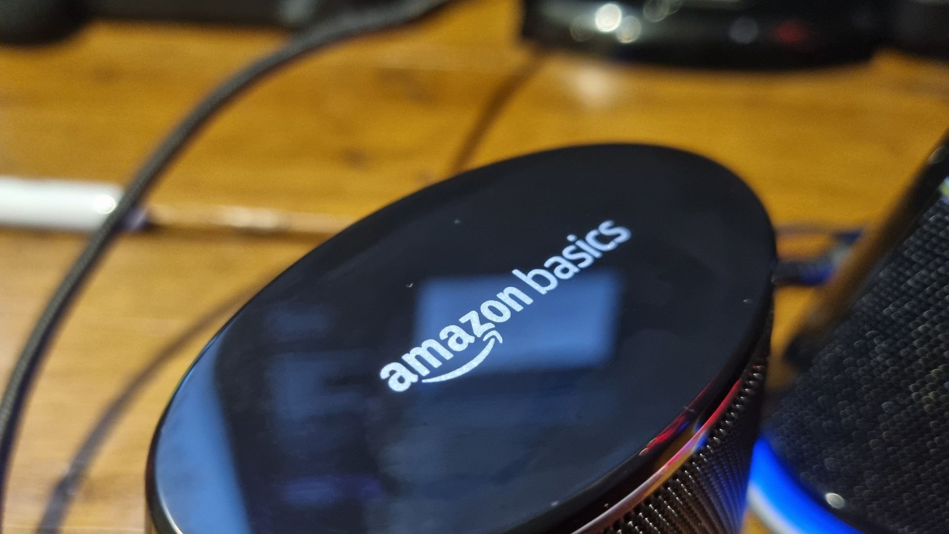 The Amazon Basics Stereo 2.0 speakers on a desktop, shot from various angles
