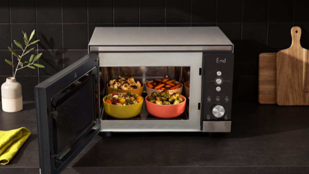 Ninja Crispi Microwave on kitchen counter containing stuffed peppers