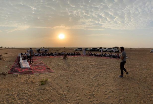 The riders enjoy the sun rise in the desert