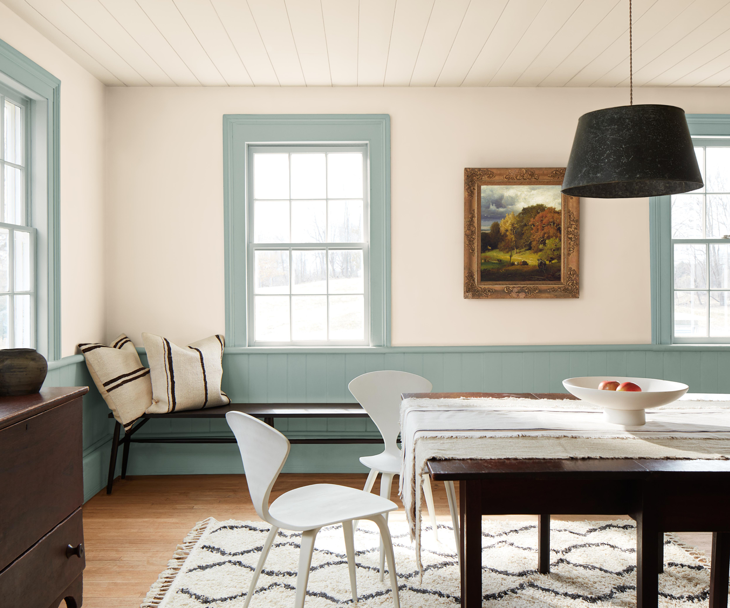 dining roo with white walls, blue panelling and blue woodwork and window frames