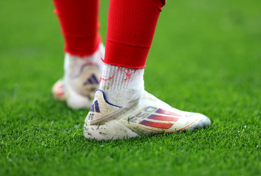 A detailed view of the Adidas F50 Elite Laceless football boots worn by Nuno Mendes of Portugal during the UEFA EURO 2024 group stage match between Turkiye and Portugal at Football Stadium Dortmund on June 22, 2024 in Dortmund, Germany. How much do football boots cost? 