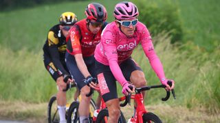 Geraint Thomas leads the Giro d'Italia 2023 wearing the pink jersey on his bike
