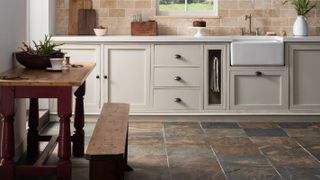 multi coloured slate flooring in cream kitchen