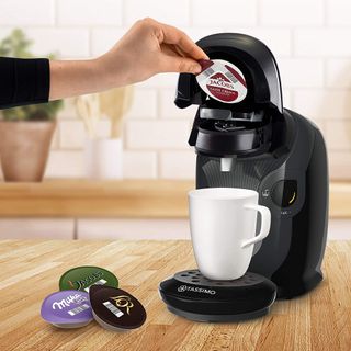 Image of someone putting coffee pod into Tassimo by Bosch Style coffee machine