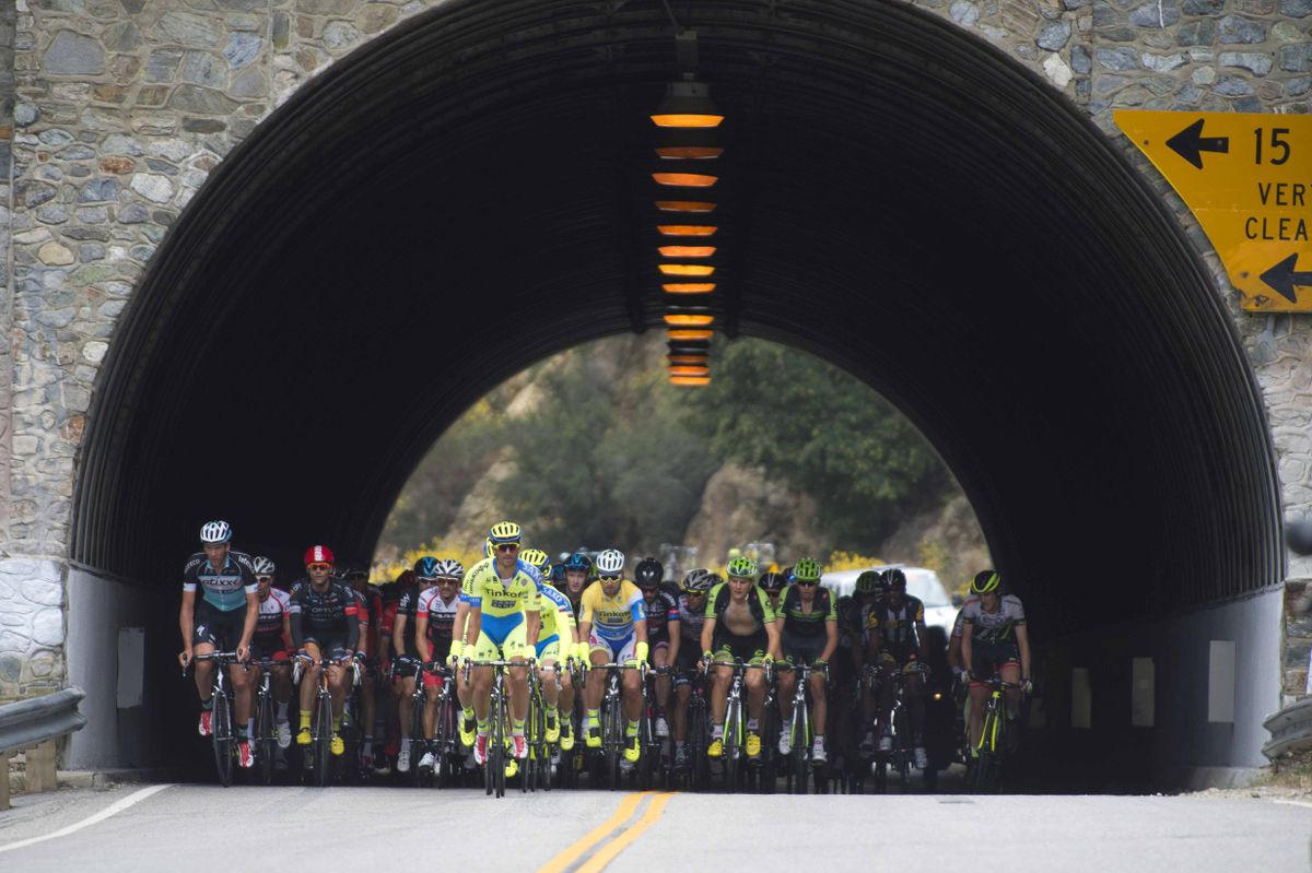 The peloton comes out of a tunnel