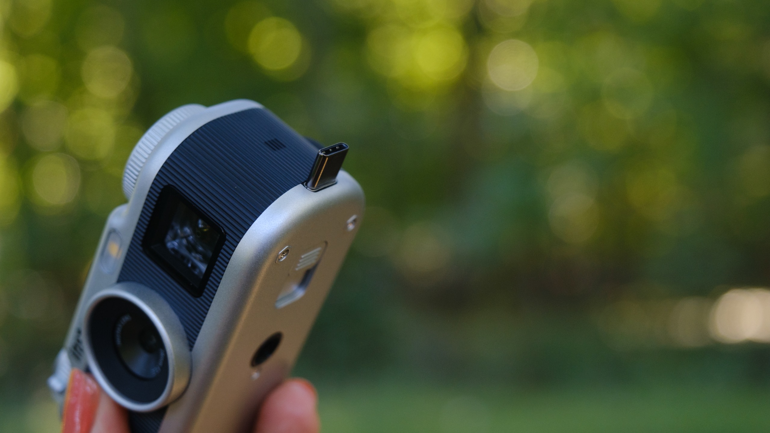 The Instax Pal 2 held in a photographer's hands
