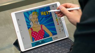 A person drawing a pop-art image on an iPad Air 2019