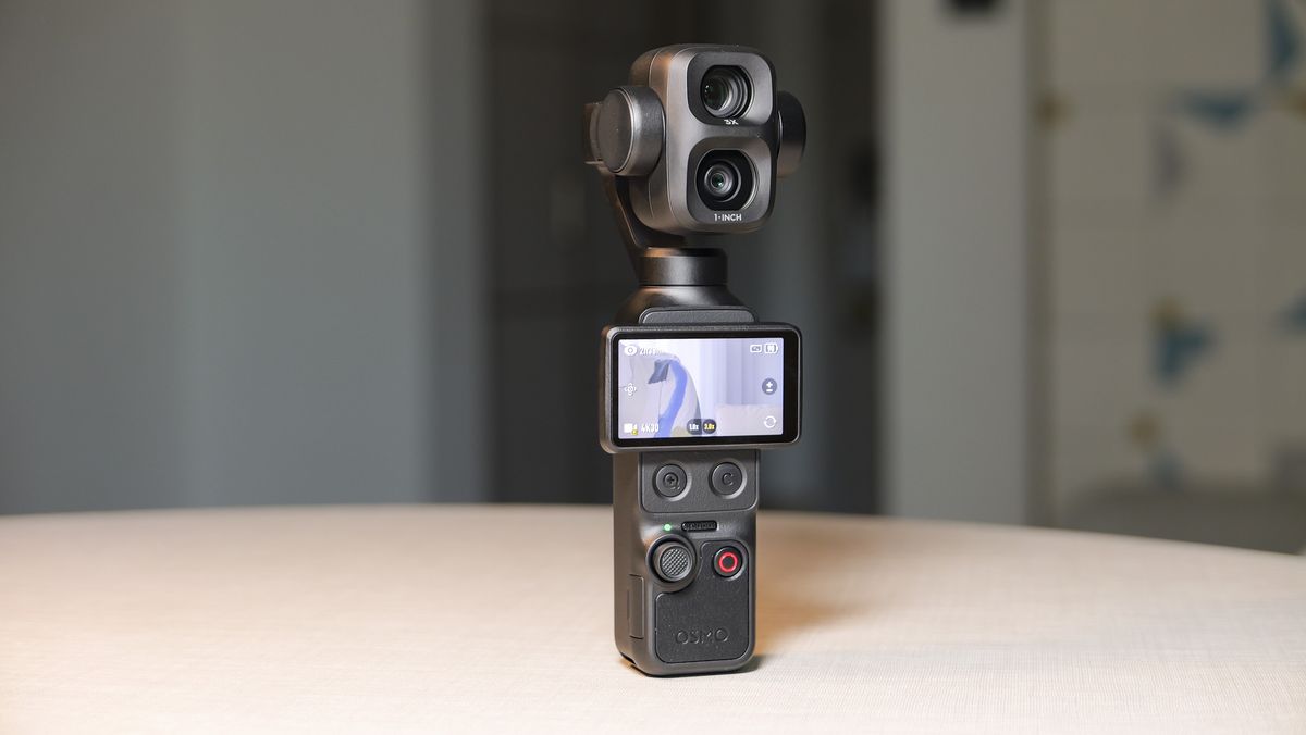 DJI Osmo Pocket 4P vlogging camera on a white desk in modern room