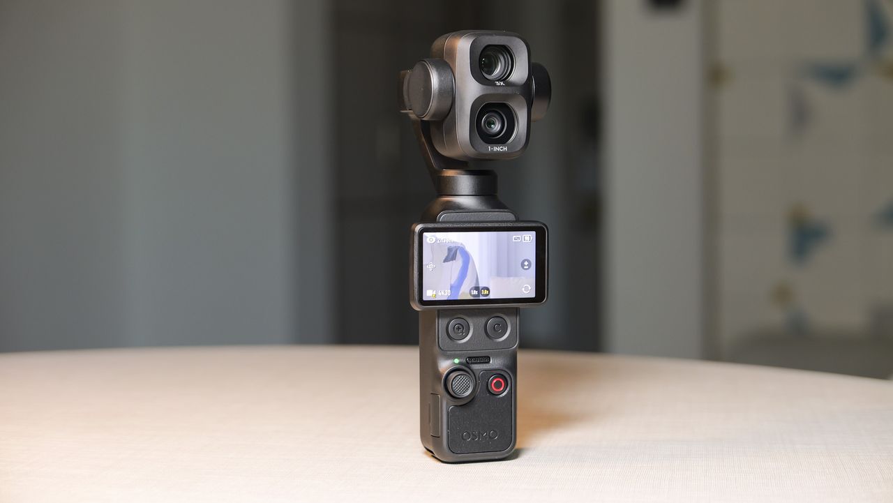 DJI Osmo Pocket 4P vlogging camera on a white desk in modern room