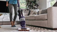 A Shark Rotator Pet Lift-Away Upright Vacuum on a carpet