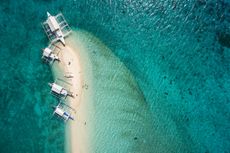 Invest in Philippines aerial view of outrigger boats on sand bar 