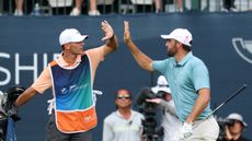 Scottie Scheffler (right) and stand-in caddie, Michael Cromie high five during the final round of the 2025 BMW Championship