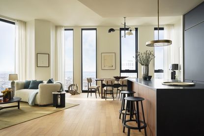 open plan living room kitchen and diner with white furniture in a city apartment