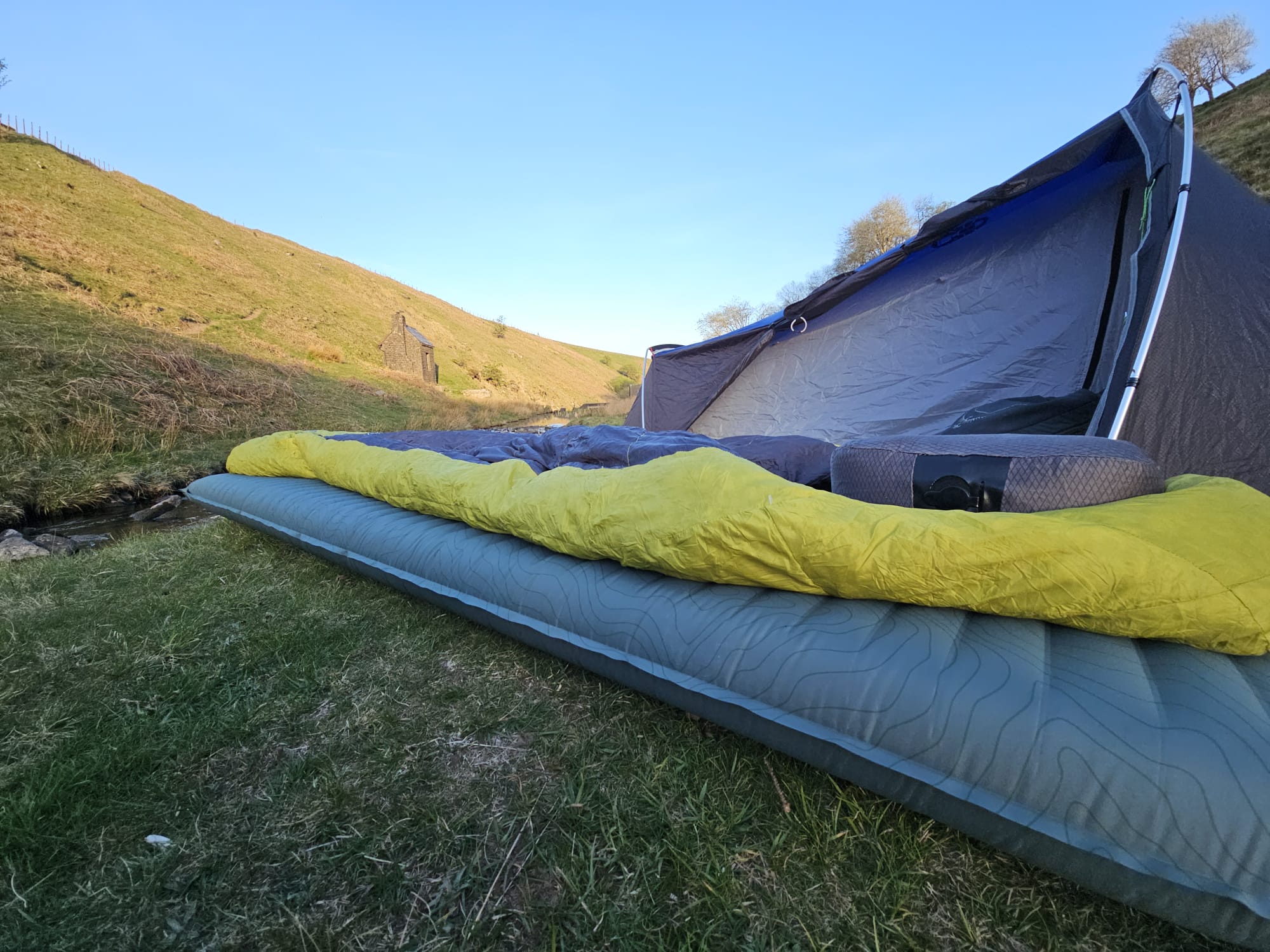 Thermarest sleeping mat shown in front of a backpacking tent